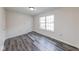 Bright bedroom features new wood-look flooring and a large window at 7621 Orchard Village Dr, Indianapolis, IN 46217
