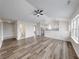 Inviting living room features vaulted ceilings, modern ceiling fan, and new wood-look flooring at 7621 Orchard Village Dr, Indianapolis, IN 46217