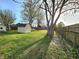 Landscaped backyard featuring a storage shed and a wood fence with a glimpse of the house at 8143 Filly Ln, Plainfield, IN 46168