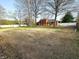 Expansive backyard featuring a well-maintained lawn, mature trees, and a view of the home's rear exterior at 8143 Filly Ln, Plainfield, IN 46168