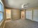 Bedroom with neutral carpet, large window, ceiling fan, and access to the bathroom at 8143 Filly Ln, Plainfield, IN 46168