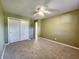 Bedroom featuring neutral carpet, closet, and ceiling fan at 8143 Filly Ln, Plainfield, IN 46168