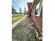 Close-up view of the home's brick exterior with decorative shutters and a well-maintained lawn at 8143 Filly Ln, Plainfield, IN 46168