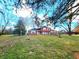 Charming two-story home with brick and red siding, landscaped yard, and mature trees at 8143 Filly Ln, Plainfield, IN 46168