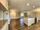Kitchen island with granite countertops, stainless steel appliances, and hardwood floors at 8143 Filly Ln, Plainfield, IN 46168