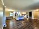 Open floor plan featuring hardwood floors, kitchen island, and staircase at 8143 Filly Ln, Plainfield, IN 46168