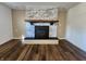 Bright living room featuring a brick fireplace, hardwood floors, and neutral paint at 8143 Filly Ln, Plainfield, IN 46168