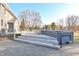 Backyard view showcasing a wooden deck with steps leading to a sunken hot tub area at 8513 Shelbyville Rd, Indianapolis, IN 46259