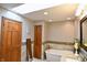 Bright bathroom with skylight, soaking tub, and tiled walls, offering a relaxing atmosphere at 8513 Shelbyville Rd, Indianapolis, IN 46259