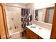 Well-lit bathroom featuring a tub and shower combo with a single vanity at 8513 Shelbyville Rd, Indianapolis, IN 46259