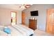 Bedroom showing ceiling fan, carpet flooring, dresser, and ensuite bathroom access at 8513 Shelbyville Rd, Indianapolis, IN 46259