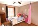 A bright bedroom features plush decor, soft carpet and a lovely window at 8513 Shelbyville Rd, Indianapolis, IN 46259