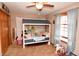 A cute bedroom featuring an elevated bed, plush carpet and light blue window coverings at 8513 Shelbyville Rd, Indianapolis, IN 46259