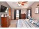 Cozy bedroom with ceiling fan, multiple dressers, plush carpet, and great natural light at 8513 Shelbyville Rd, Indianapolis, IN 46259