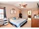 Bedroom featuring ceiling fan, carpet flooring, dresser, and tasteful decor elements at 8513 Shelbyville Rd, Indianapolis, IN 46259