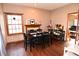 Dining room with wood floors, a window for natural light, and comfortable seating at 8513 Shelbyville Rd, Indianapolis, IN 46259
