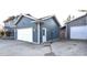 Attached garage featuring a garage door, side door, and yard at 8513 Shelbyville Rd, Indianapolis, IN 46259