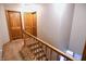 Upstairs hallway features wood doors, carpeted floors, and neutral wall color at 8513 Shelbyville Rd, Indianapolis, IN 46259