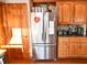 Kitchen nook featuring stainless steel refrigerator and wood cabinetry and stainless appliances at 8513 Shelbyville Rd, Indianapolis, IN 46259