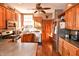 Well-lit kitchen with wood cabinets, stainless steel appliances, and mosaic tile backsplash at 8513 Shelbyville Rd, Indianapolis, IN 46259