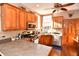 Bright kitchen with stainless steel appliances, wooden cabinets, a mosaic backsplash, and natural light from multiple windows at 8513 Shelbyville Rd, Indianapolis, IN 46259
