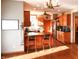 Bright eat-in kitchen with wooden cabinets, island seating, and stainless steel appliances at 8513 Shelbyville Rd, Indianapolis, IN 46259