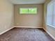 This carpeted bedroom features natural light from a window; fresh, neutral paint at 922 N Oakland Ave, Indianapolis, IN 46201