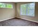 This cozy bedroom offers great natural light from large windows, complemented by neutral walls and carpet at 922 N Oakland Ave, Indianapolis, IN 46201