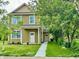Two-story home with a landscaped yard and walkway leading to the front door at 922 N Oakland Ave, Indianapolis, IN 46201