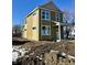 Two-story home with pale yellow and olive green siding, white trim, and a covered front porch at 922 N Oakland Ave, Indianapolis, IN 46201
