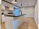 Modern kitchen features an island with a black countertop and white cabinets at 922 N Oakland Ave, Indianapolis, IN 46201