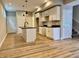 Open kitchen with an island, stainless appliances, white cabinetry, and wood flooring at 922 N Oakland Ave, Indianapolis, IN 46201