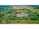 Aerial view of a property with a large home, pond, surrounded by trees and farmland at 9615 N County Road 150 E Rd, Pittsboro, IN 46167
