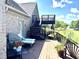 Spacious back deck with a grill, lounge chairs, stairs, a fenced in side yard and landscaping at 9615 N County Road 150 E Rd, Pittsboro, IN 46167