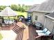 Wide angle of back deck with gazebo, lounge chairs, grill, and green backyard at 9615 N County Road 150 E Rd, Pittsboro, IN 46167
