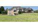Beautiful backyard with a well-maintained lawn, mature landscaping, and a spacious deck for outdoor entertaining at 9615 N County Road 150 E Rd, Pittsboro, IN 46167