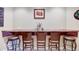 Basement bar with a brown marble countertop, brown wooden chairs, and a flower centerpiece at 9615 N County Road 150 E Rd, Pittsboro, IN 46167