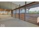 Indoor barn with wooden horse stalls with access to a paddock at 9615 N County Road 150 E Rd, Pittsboro, IN 46167