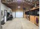 Horse barn featuring finished walls, stalls and a garage door providing access to the outside at 9615 N County Road 150 E Rd, Pittsboro, IN 46167