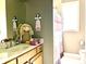 Bathroom featuring a vanity sink, decorative doll, and a shower with a patterned curtain at 9615 N County Road 150 E Rd, Pittsboro, IN 46167