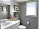 This neutral bathroom has a white vanity, toilet, and gray painted walls at 9615 N County Road 150 E Rd, Pittsboro, IN 46167