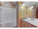 Cozy bathroom featuring wood paneling, bathtub, and sink with a vanity at 9615 N County Road 150 E Rd, Pittsboro, IN 46167