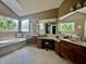 Bright bathroom with and sinks, large windows, garden tub, and granite countertops at 9615 N County Road 150 E Rd, Pittsboro, IN 46167