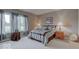 Well-lit bedroom with soft carpet, neutral paint, bright windows, and decorative accents at 9615 N County Road 150 E Rd, Pittsboro, IN 46167