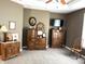 Bedroom with neutral walls, plush carpet, and dark wood dressers offering functional storage space at 9615 N County Road 150 E Rd, Pittsboro, IN 46167