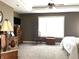 Spacious bedroom with plush carpet, a ceiling fan, and ample natural light from the large window at 9615 N County Road 150 E Rd, Pittsboro, IN 46167