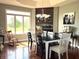 Dining room includes a large window with a backyard view, hardwood flooring, and a wooden hutch at 9615 N County Road 150 E Rd, Pittsboro, IN 46167