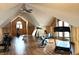 This large home gym has wood-paneled walls, wood floors, several exercise machines and natural light at 9615 N County Road 150 E Rd, Pittsboro, IN 46167