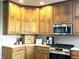 The well-lit kitchen is detailed with traditional wood cabinets, stainless appliances, and light-colored countertops at 9615 N County Road 150 E Rd, Pittsboro, IN 46167