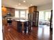Full kitchen view showcases wood cabinets, stainless appliances, an island, and hardwood floors at 9615 N County Road 150 E Rd, Pittsboro, IN 46167